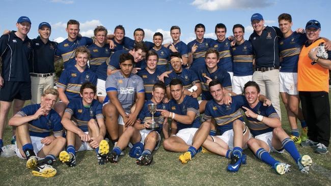 The champion 2014 Churchie team which won GPS schools rugby undefeated. Kalyn Ponga (2nd from right), Mack Mason (holding trophy), and Jaydn Su’A (to his right).