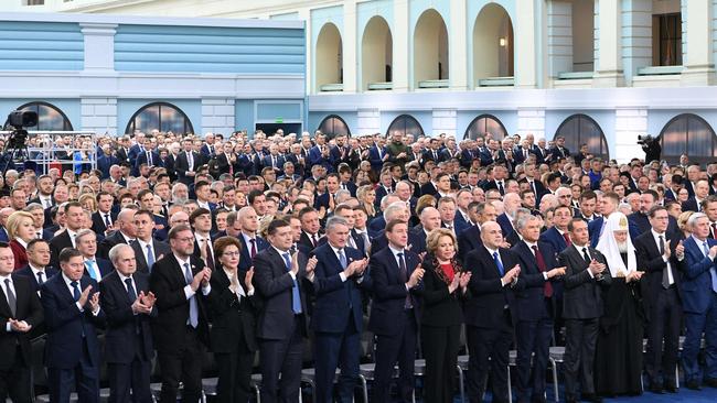 Attendees applaud as Vladimir Putin delivers his annual state of the nation address. Picture: SPUTNIK / AFP.