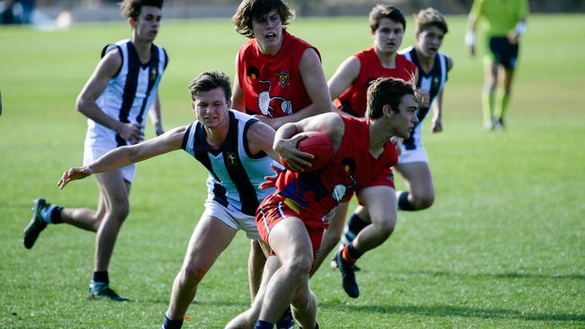 Trinity’s Josh Pearson with the ball in Saturday’s match against Immanuel. Picture: AAP/ Morgan Sette