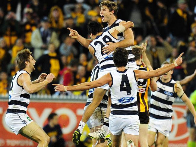 Tom Hawkins and his Geelong teammates celebrate his winner against the Hawks. Picture: George Salpigtidis