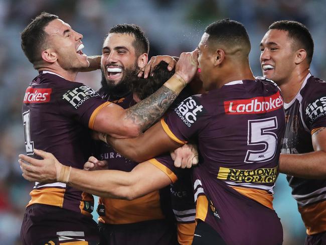 Brisbane's Darius Boyd and Jack Bird celebrate the try of James Roberts during NRL match South Sydney Rabbitohs v Brisbane Broncos at ANZ Stadium. Picture. Phil Hillyard