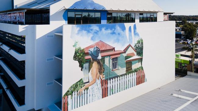 A massive mural was painted on the side of an office tower built in Beenleigh, on land originally deemed surplus. The building was sold to a private company and leased back to the council as office space. Picture: investLogan