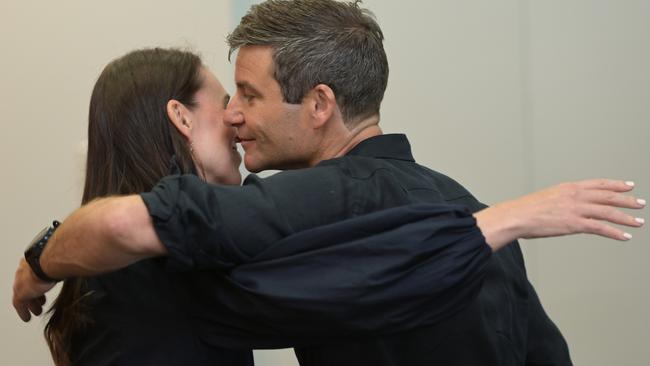 Jacinda Ardern embraces partner Clarke Gayford after she announces her resignation. Picture: Getty Images.