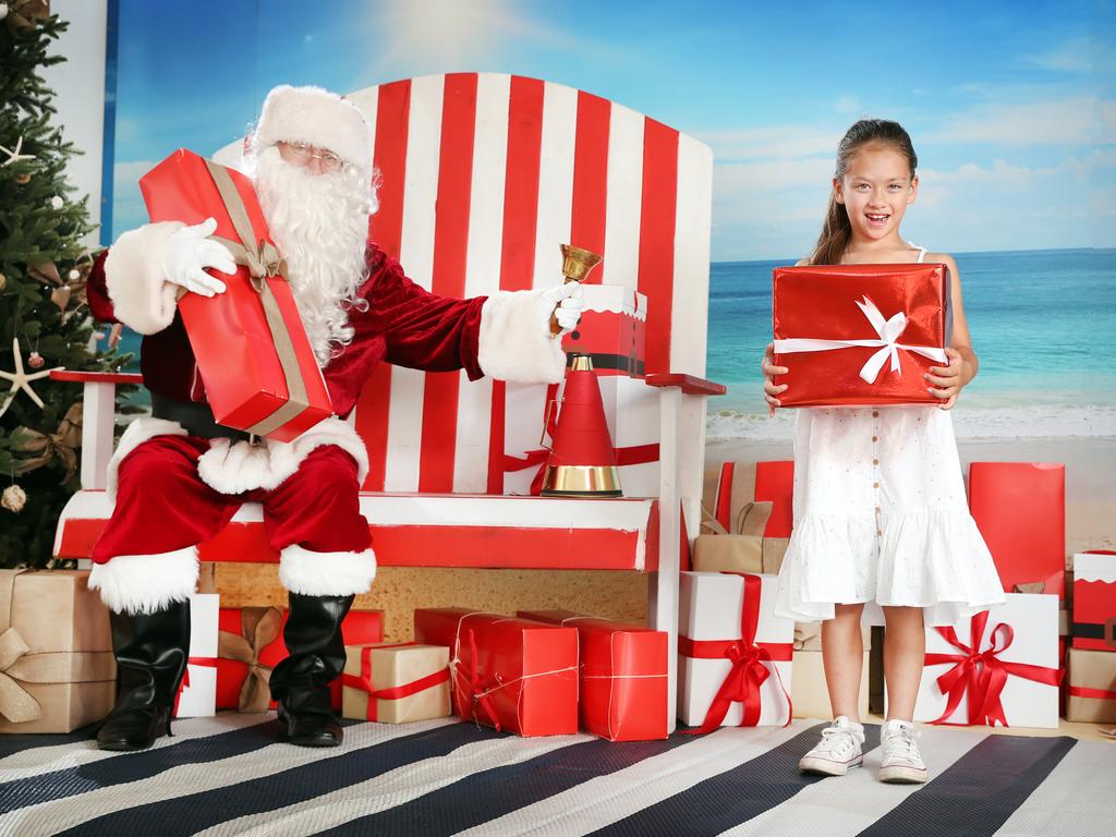 Pictured in Cronulla is a socially distanced Santa with local girl Edie Docherty (7).
Children have had their minds eased knowing that Santa will go about his Christmas 2020 duties in a socially distanced fashion.
Picture: Richard Dobson