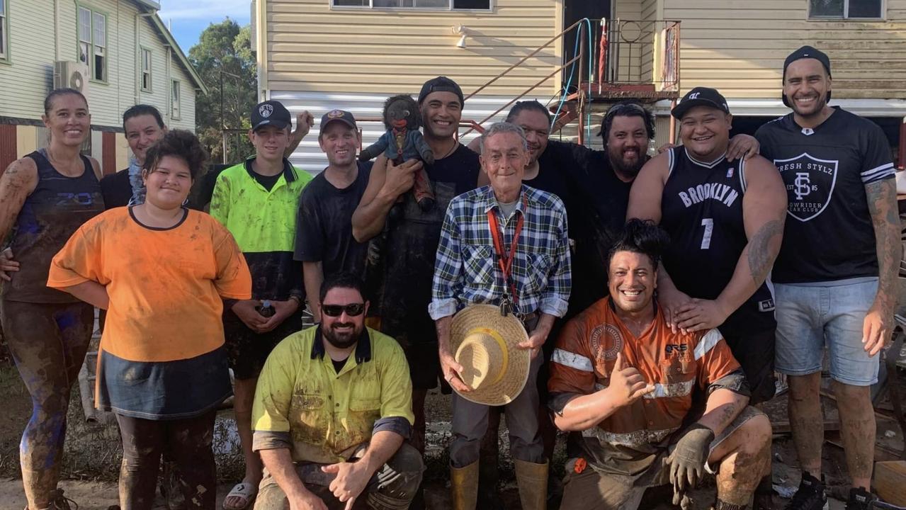 Bill Walsh, 69, surrounded by family friends who helped clean up his Lismore home after he was rescued from raging waters.