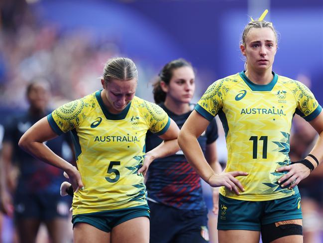 PARIS, FRANCE - JULY 30: Teagan Levi #5 and Bridget Clark #11 of Team Australia of Team Australia looks dejected following defeat during the Women's Rugby Sevens Bronze medal match between Team Canada and Team Australia on day four of the Olympic Games Paris 2024 at Stade de France on July 30, 2024 in Paris, France. (Photo by Cameron Spencer/Getty Images)