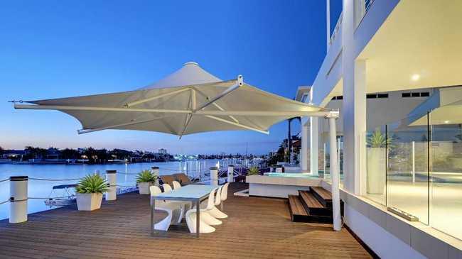 Outdoor entertaining area and deck of a waterfront Minyama home. Picture: Brad Filliponi