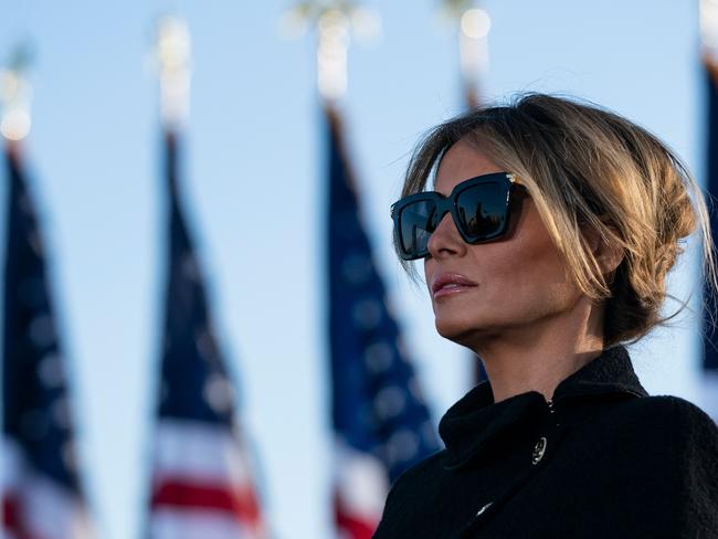 (FILES) In this file photo outgoing First Lady Melania Trump listens as her husband Outgoing US President Donald Trump addresses guests at Joint Base Andrews in Maryland on January 20, 2021. - The backdrop of flowers, teapot and US flag said it all: Jill Biden will be no Melania Trump as America's new first lady. Where Donald Trump's ex-model wife cut a flashy but often distant figure, Jill Biden's appearance on a Zoom "virtual tea" party February 3 with military spouses affirmed her image as a down-to-earth, traditional FLOTUS. (Photo by ALEX EDELMAN / AFP)