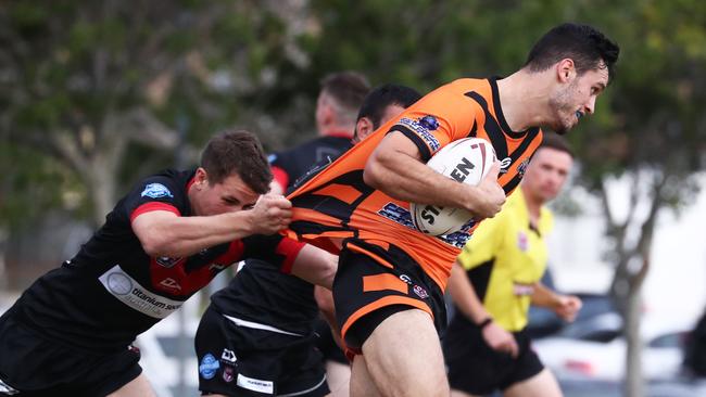 Southport Tigers' Curtis Dainsey-Smaller runs at the Mudgeeraba Redbacks defence during their Gold Coast Rugby League A Grade match at Owen Park Southport . Photograph : Jason O'Brien