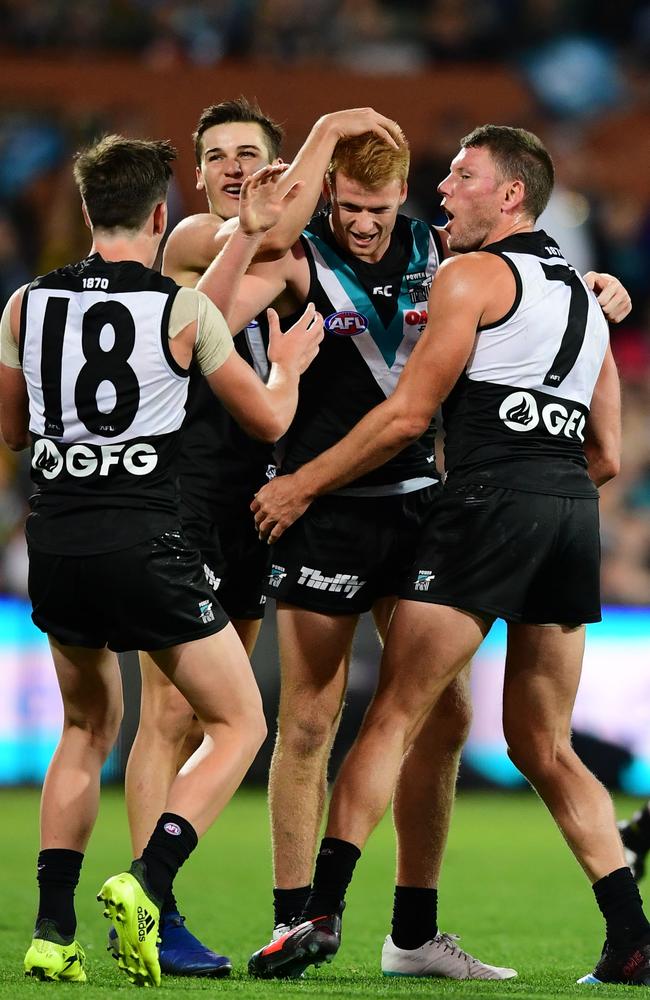 Willem Drew celebrates his first goal in AFL footy with his teammates. Picture: Mark Brake (Getty)