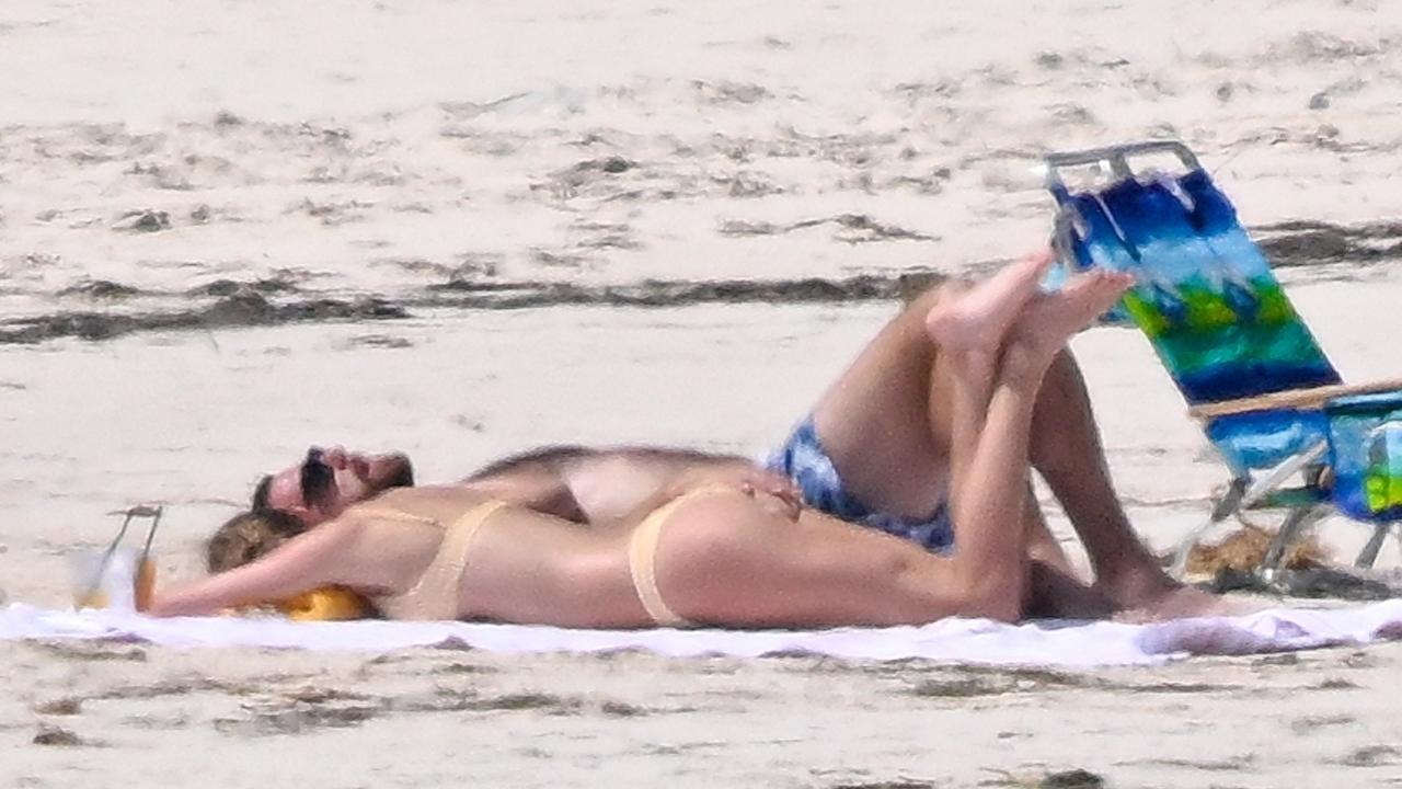 Kelce was later seen cheekily placing his hand on Swift’s bum as they soaked up the sunshine on the beach. Picture: Backgrid