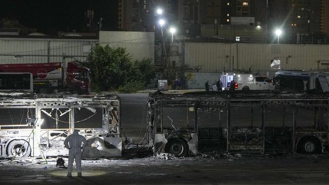 Israeli police inspect the wrecked buses in Bat Yam, central Israel, on Thursday. Picture: AP