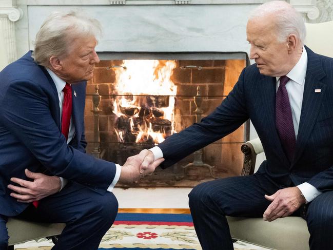 US President Joe Biden shakes hands with US President-elect Donald Trump during a meeting in the Oval Office of the White House in Washington, DC, on November 13, 2024. (Photo by SAUL LOEB / AFP)