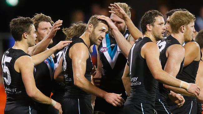 Jay Schulz, in his final game for Port Adelaide, celebrates a goal with teammates.