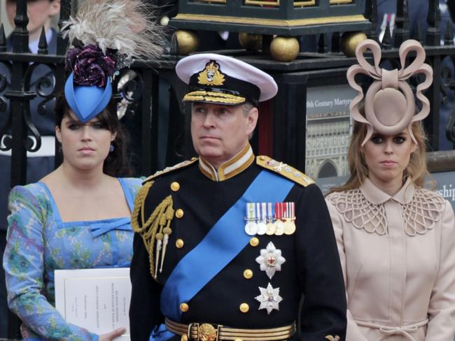 FILE - In this file photo dated Friday, April, 29, 2011, Britain's Prince Andrew, center, and his daughters Britain's Princess Eugenie, left, and Princess Beatrice leave Westminster Abbey at the Royal Wedding of Prince William to Cathgerine Middleton, to become Kate Duchess of Cambridge, in London. Prince Andrew said Wednesday Nov. 20, 2019, that he is stepping back from public duties with the queen's permission, saying that recent disclosures regarding his association with the late convicted sex offender Jeffrey Epstein have become a â€œmajor distractionâ€ to the royal familyâ€™s work.(AP Photo/Gero Breloer, FILE)