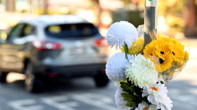 Flowers left on a pole at the intersection of Bridge Road and Peats Ferry Road in Hornsby following the death of an 81-year-old pedestrian in May.