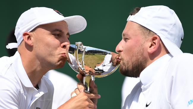 Britain's Andy Lapthorne (L) and Australia's Dylan Alcott kiss their trophy. Picture: AFP