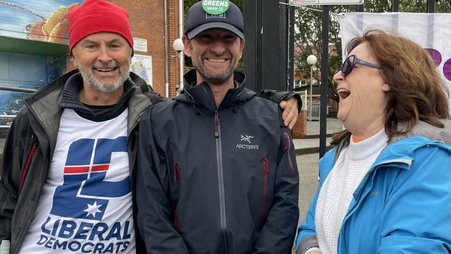 Supporters Steve Forkin (Liberal Democrats), Mark Graham (Greens) and Jane Raynor (Pauline Hanson's One Nation) share a laugh outside Coffs Harbour High School. Picture: Chris Knight