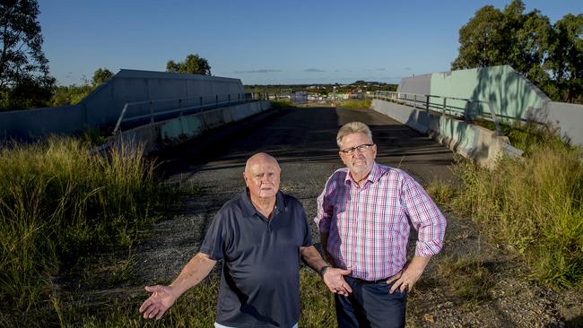 Developer Norm Rix and State Member for Coomera, Michael Crandon want to open up the unused bridge. Picture: Jerad Williams