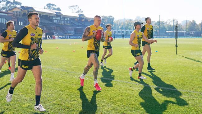 Richmond’s Dustin Martin, centre, and teammates return to action as a team at Punt Rd Oval