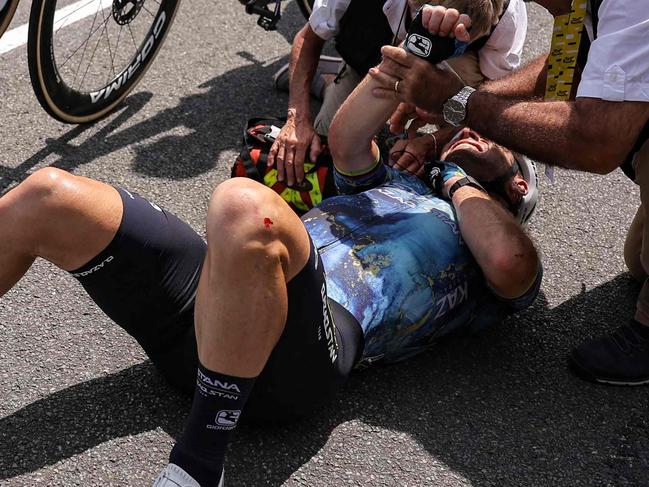 Astana Qazaqstan Team's British rider Mark Cavendish receives medical attention after crashing during the 8th stage of the 110th edition of the Tour de France cycling race, 201 km between Libourne and Limoges, in central western France, on July 8, 2023. (Photo by Thomas SAMSON / AFP)