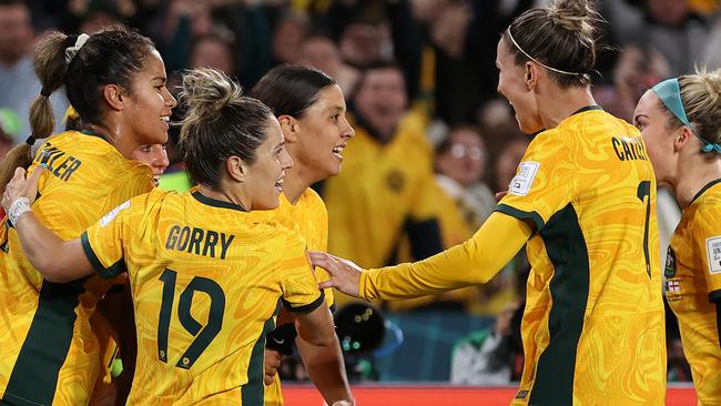 SYDNEY, AUSTRALIA - AUGUST 16: Sam Kerr (C) of Australia celebrates with teammates after scoring her team's first goal  during the FIFA Women's World Cup Australia & New Zealand 2023 Semi Final match between Australia and England at Stadium Australia on August 16, 2023 in Sydney, Australia. (Photo by Brendon Thorne/Getty Images)