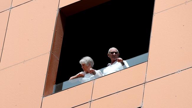 Quarantined hotel quests on the balcony of the Peppers on Waymouth Hotel in Adelaide. Picture: Kelly Barnes/Getty Images