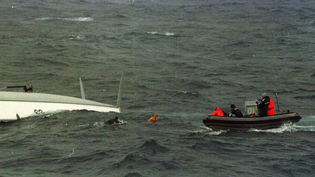 Missing yachtsman Tony Bullimore (centre) emerges from beneath the hull of his upturned yacht Exide Challenger to meet rescuers from HMAS Adelaide on January 1997.