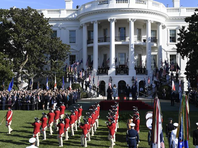 President Donald Trump and first lady Melania Trump and Australian Prime Minister Scott Morrison and his wife Jenny Morrison watch troops march during a state arrival ceremony on the South Lawn of the White House in Washington. Picture: AP