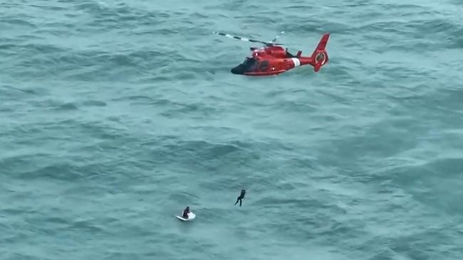 About 40 hours after the hurricane hit, this man was rescued by the Coast Guard, clinging to an esky and wearing a life jacket. He is a fisherman who went back out to sea to repair a broken boat before the storm hit. Picture: US Coast Guard / AFP