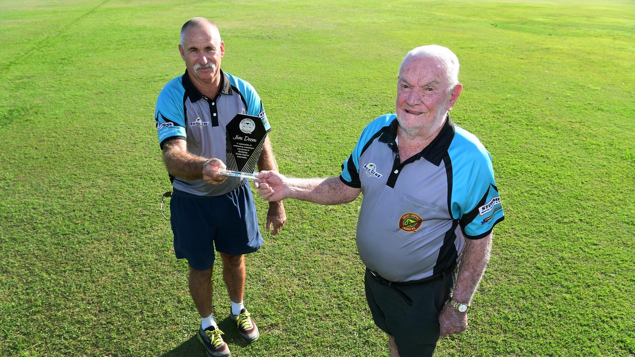 Mick Clarry presents Jim Deem with a plaque for his services to Bundy cricket over the past 50 years.