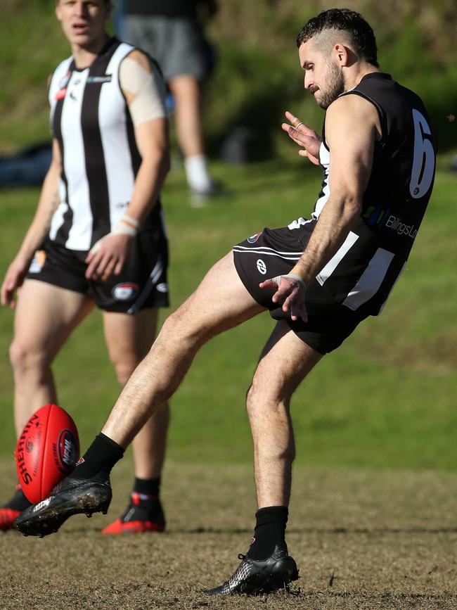 Jai Robinson gets a kick for Montmorency. Picture: Hamish Blair