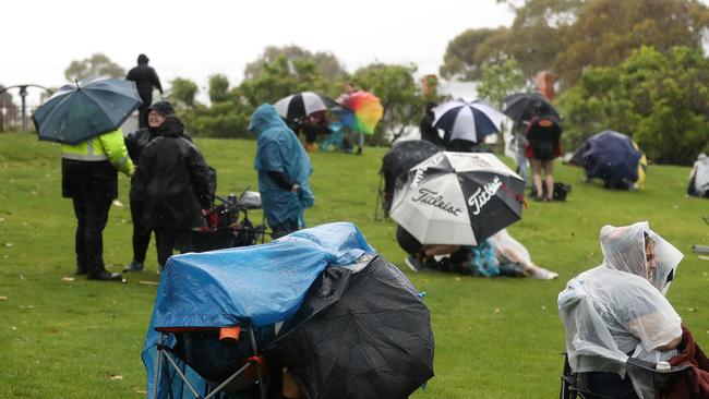 Footy fans hide from the elements as lightning strikes and bad weather strikes during the 2022 AFLW. Picture: Sarah Reed/AFL Photos via Getty Images