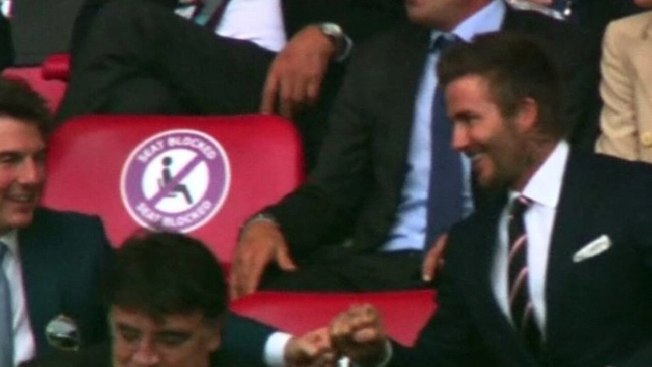 Cruise (left) and Beckham watch a football match together.