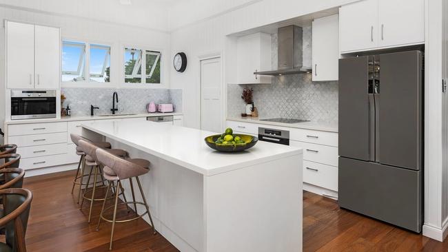 The property boasts a designer kitchen with marble tiles and Miele appliances. Picture: Contributed