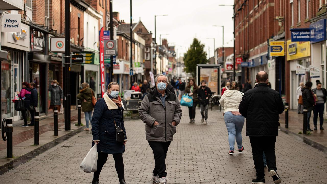 Shoppers wearing face masks walk in the High Street of Leigh, Greater Manchester, northwest England/ Picture: Oli Scarff/AFP