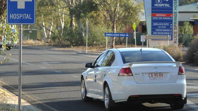 Police say the woman died when she ‘fell on the road’ outside the Alice Springs Hospital on Monday evening.