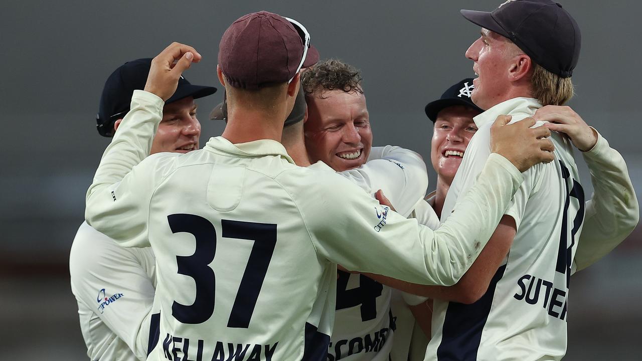 Peter Siddle is mobbed after taking a final wicket with his final ball. Picture: Paul Kane/Getty Images