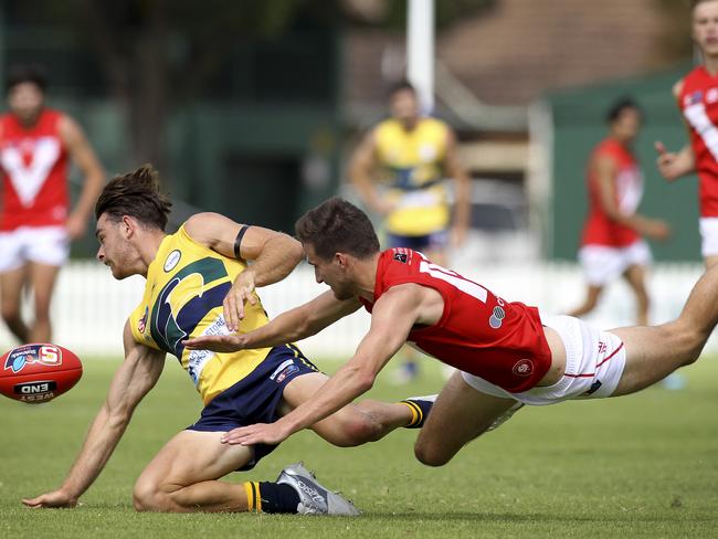 SANFL: Eagles v North Adelaide at Woodville Oval. North's Tom Schwarz dives for the ball with Eagle's Jordan Foote. 31 March 2019. (AAP Image/Dean Martin)