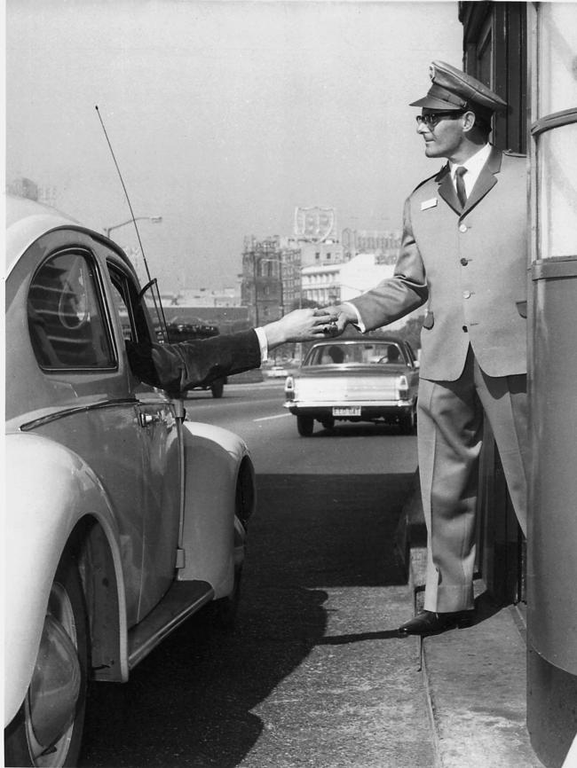 A toll booth operator collects the toll from motorists on the Sydney Harbour Bridge. Picture: News Limited.