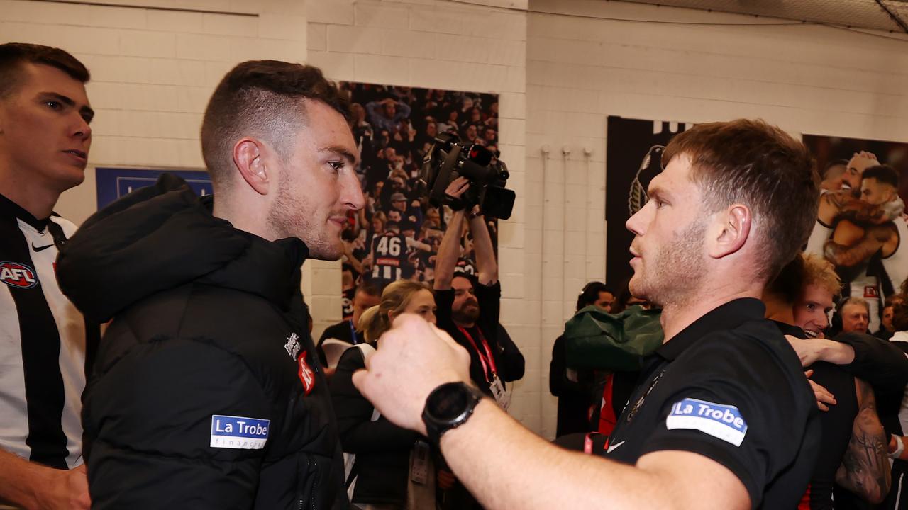 Dan McStay (left) and Taylor Adams embraced in the rooms after the Magpies’ preliminary final win on Friday night. Picture: Michael Klein