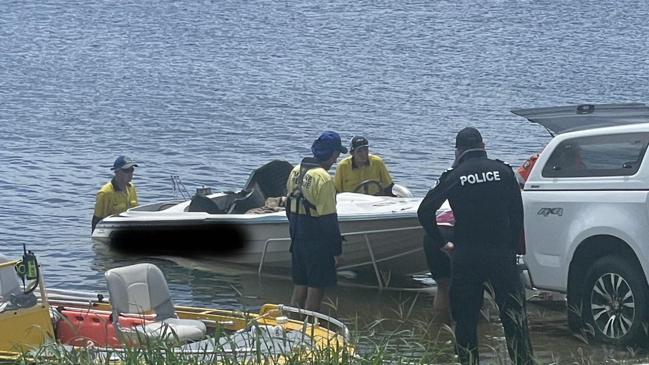 Emergency services bring the family's boat ashore at  Kinchant Dam.