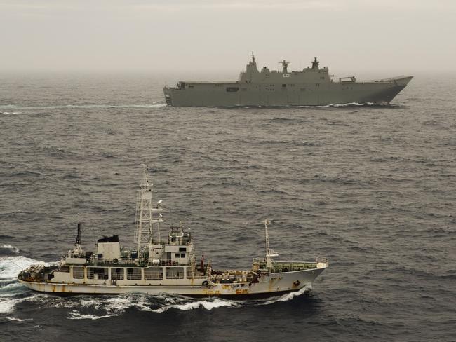 The Royal Australian Navy's HMAS Adelaide escorts the suspect vessel towards Hobart. Picture: Royal Australian Navy