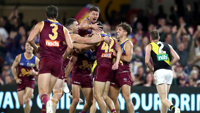 Brisbane players celebrate James Madden’s first career goal. Picture: Jono Searle/AFL Photos