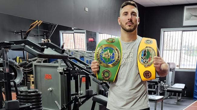 Kris Terzievski shows off his belts at Mace Fitness. Picture: Ben Higgins