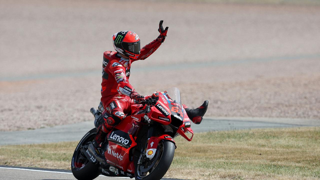 Francesco Bagnaia waves after winning the qualifying session. (Photo by Ronny Hartmann / AFP)