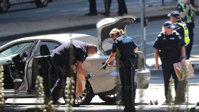 Police search the car. Picture: Alex Coppel