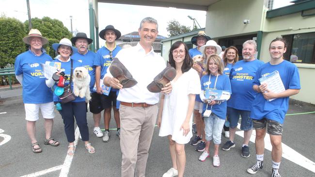 Herman Vorster with worn out shoes and his volunteers at Burleigh Heads. Picture by Richard Gosling