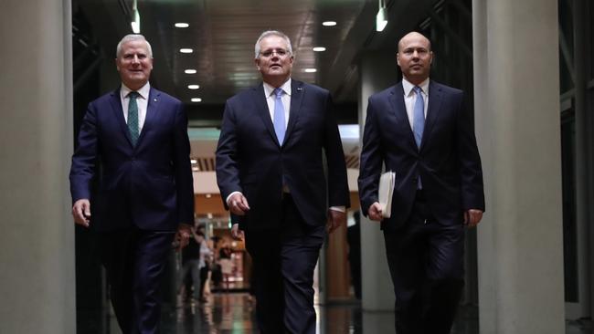 Scott Morrison, Michael McCormack and Treasurer Josh Frydenberg walk into the House of Reps chamber to deliver the Australian 2021 budget. Picture: Adam Taylor / PMO