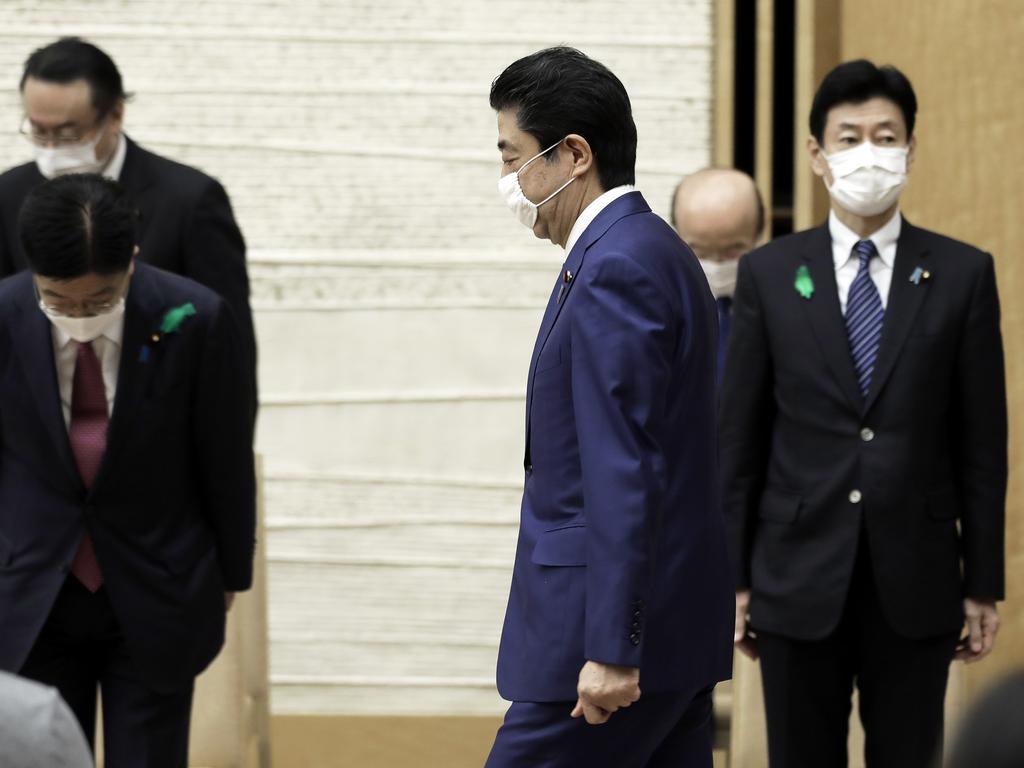 Japan's Prime Minister Shinzo Abe wearing a protective mask as he arrives for a news conference in Tokyo, Japan. Picture: Kiyoshi Ota/Pool Photo via AP